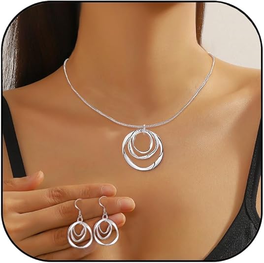 Silver necklace and earrings set on a mannequin